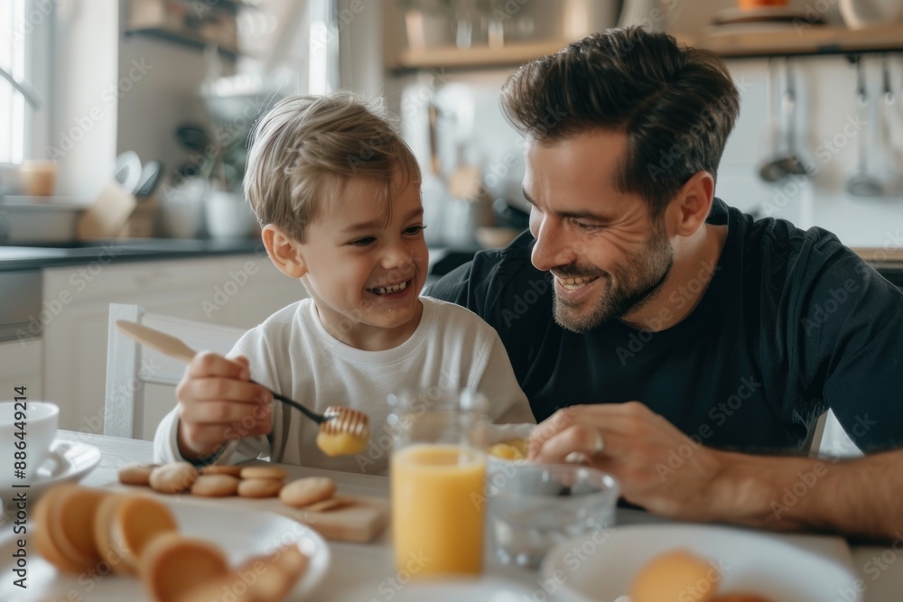 A happy father and son were having breakfast at home. A happy father and son were having breakfast at home.