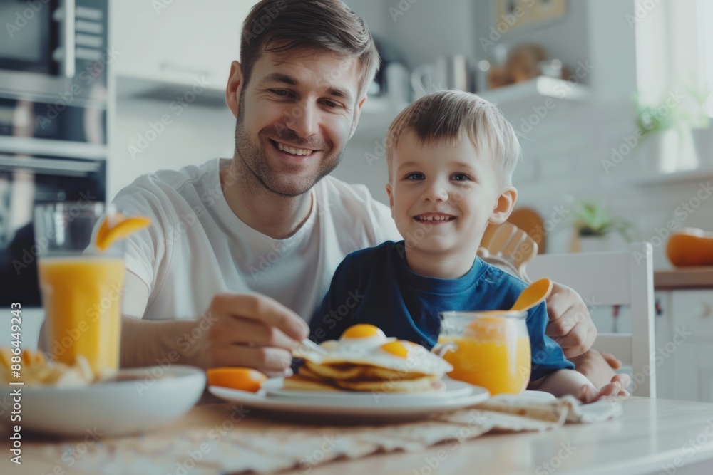 A happy father and son were having breakfast at home. A happy father and son were having breakfast at home.
