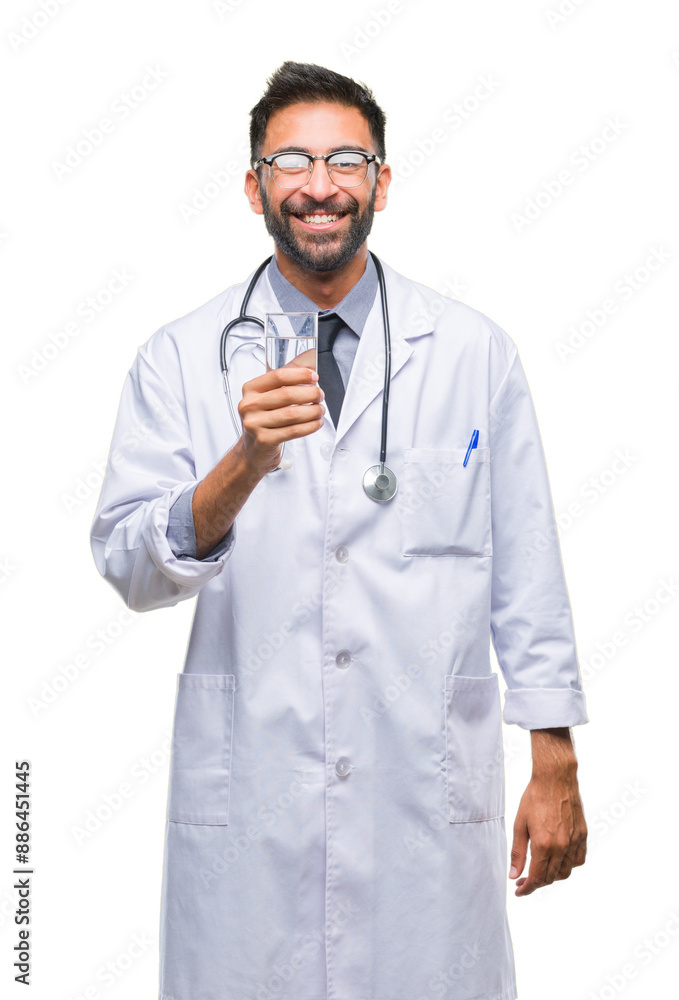 Adult hispanic doctor man drinking glass of water over isolated background with a happy face standing and smiling with a confident smile showing teeth Adult hispanic doctor man drinking glass of water over isolated background with a happy face standing and smiling with a confident smile showing teeth