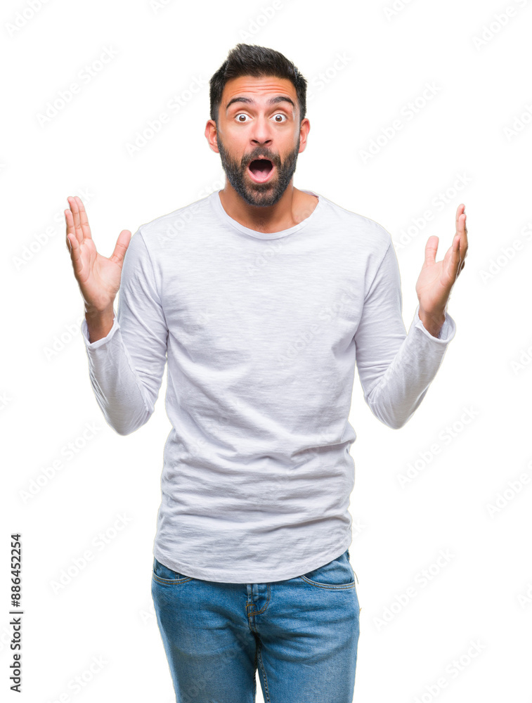 Adult hispanic man over isolated background celebrating crazy and amazed for success with arms raised and open eyes screaming excited. Winner concept Adult hispanic man over isolated background celebrating crazy and amazed for success with arms raised and open eyes screaming excited. Winner concept