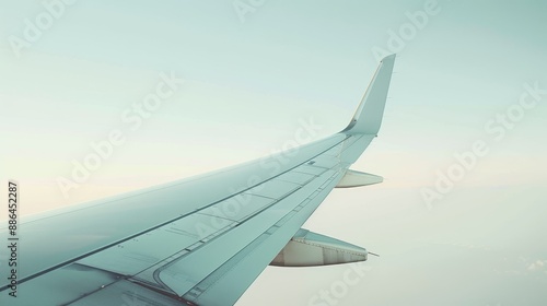 A close-up of an airplane wing against a clear sky, with space for overlaying text and images