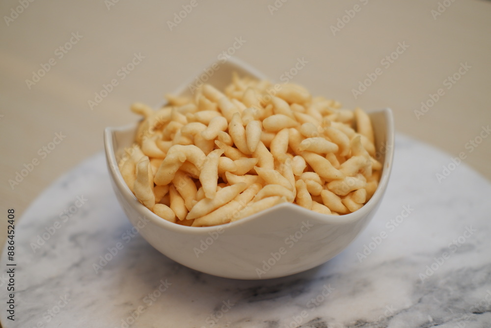 telur gabus sticks in white bowl on wooden table background. telur gabus sticks in white bowl on wooden table background.