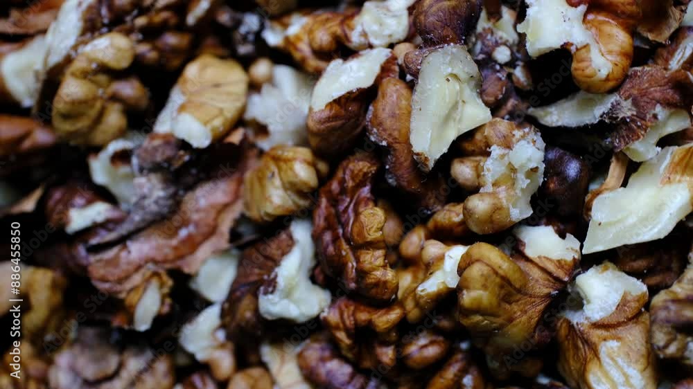 Walnut kernels on rotating ground in close-up Walnut kernels on rotating ground in close-up