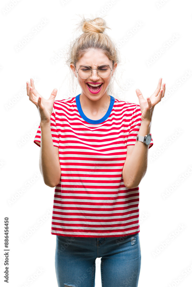 Young beautiful blonde woman wearing glasses over isolated background celebrating mad and crazy for success with arms raised and closed eyes screaming excited. Winner concept Young beautiful blonde woman wearing glasses over isolated background celebrating mad and crazy for success with arms raised and closed eyes screaming excited. Winner concept