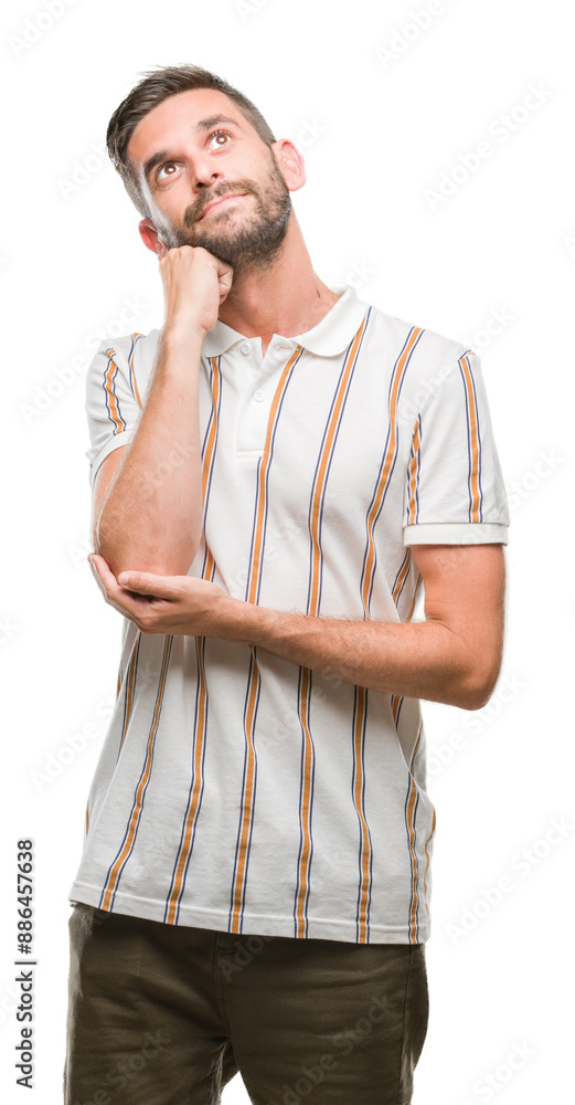 Young handsome man over isolated background with hand on chin thinking about question, pensive expression. Smiling with thoughtful face. Doubt concept. Young handsome man over isolated background with hand on chin thinking about question, pensive expression. Smiling with thoughtful face. Doubt concept.