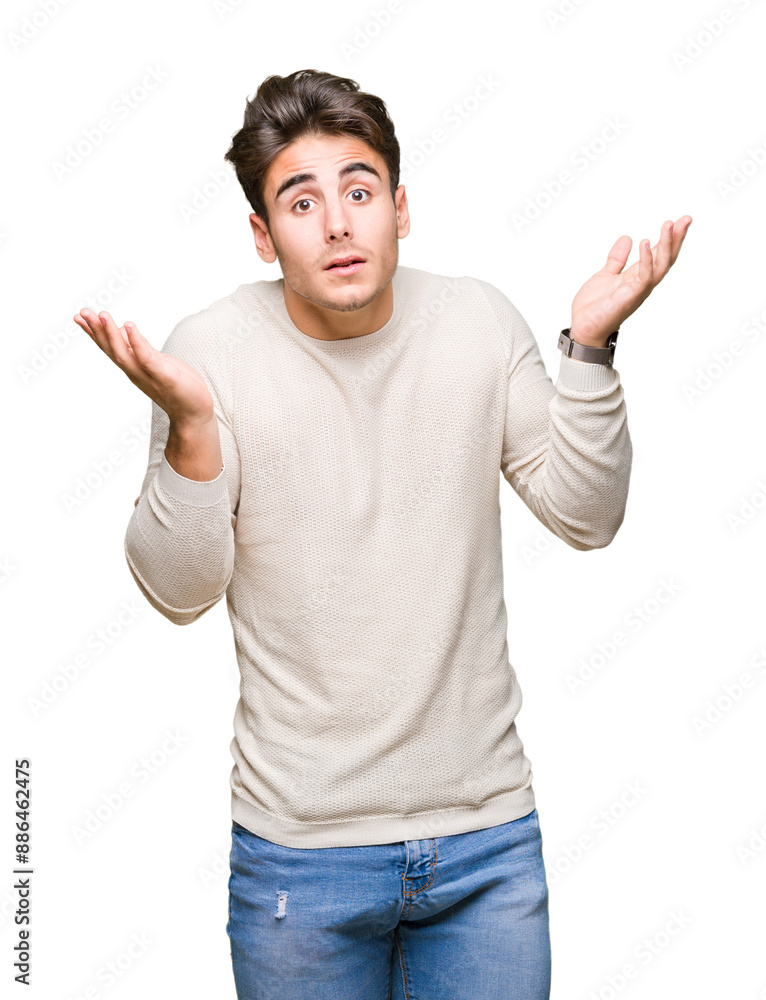 Young handsome man over isolated background clueless and confused expression with arms and hands raised. Doubt concept. Young handsome man over isolated background clueless and confused expression with arms and hands raised. Doubt concept.