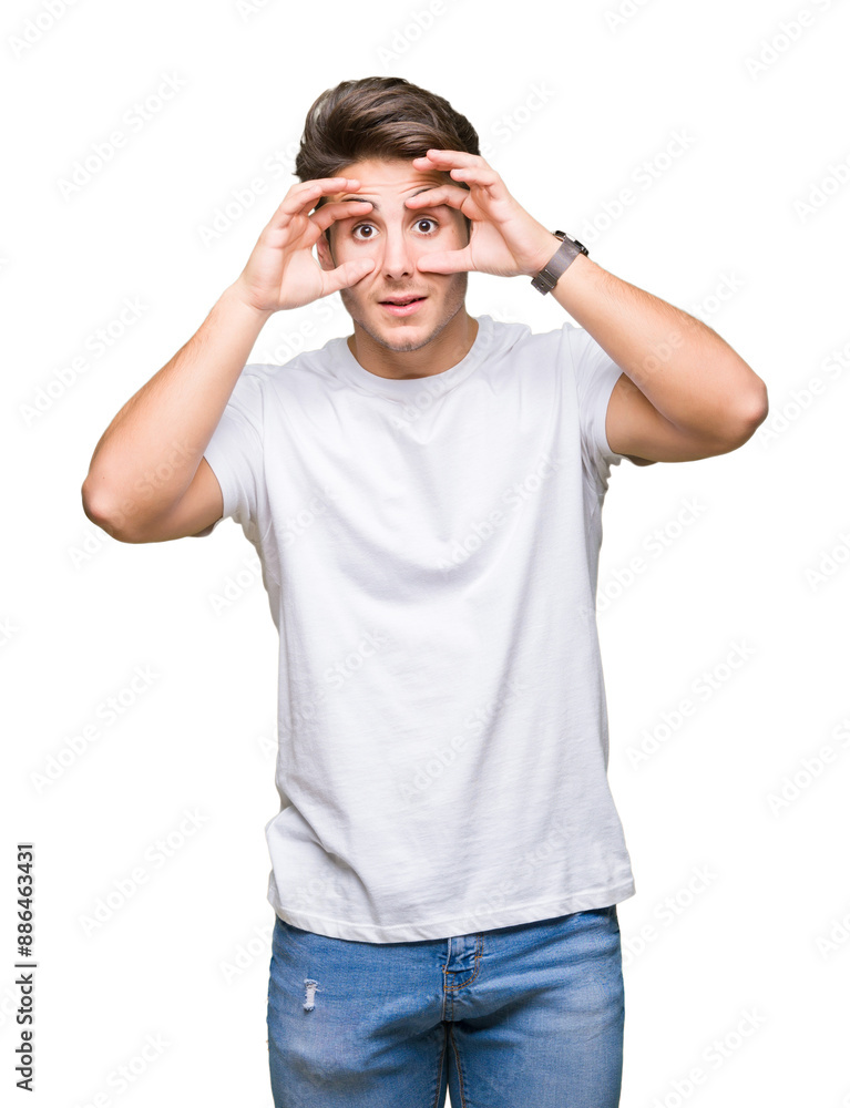 Young handsome man wearing white t-shirt over isolated background Trying to open eyes with fingers, sleepy and tired for morning fatigue Young handsome man wearing white t-shirt over isolated background Trying to open eyes with fingers, sleepy and tired for morning fatigue