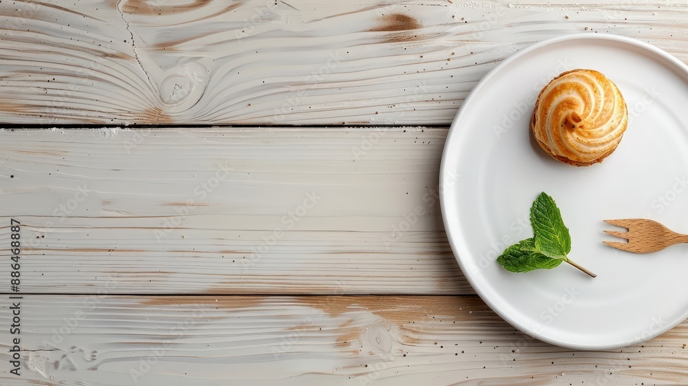 A minimalist still life of a single choux pastry puff on a white plate. A minimalist still life of a single choux pastry puff on a white plate.