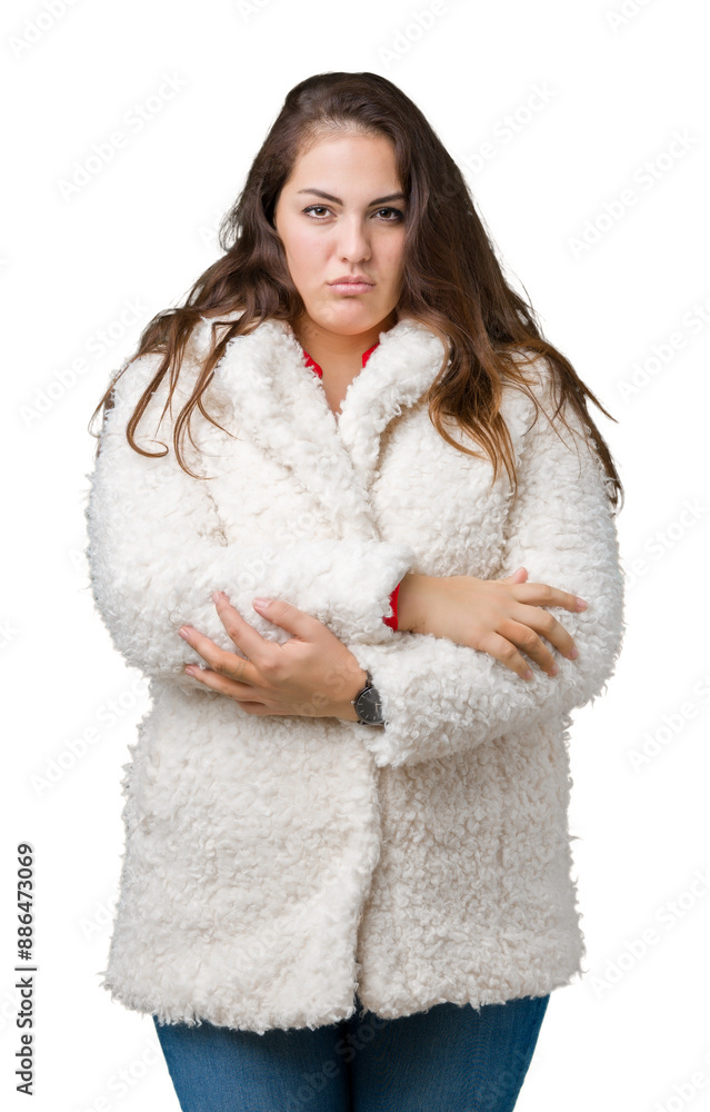Beautiful plus size young woman wearing winter sheep coat over isolated background skeptic and nervous, disapproving expression on face with crossed arms. Negative person. Beautiful plus size young woman wearing winter sheep coat over isolated background skeptic and nervous, disapproving expression on face with crossed arms. Negative person.