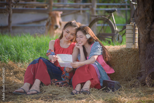 Asian beautiful rural women smiles happily when she receives a letter from her lover who is a soldier for national defense on the border. photo