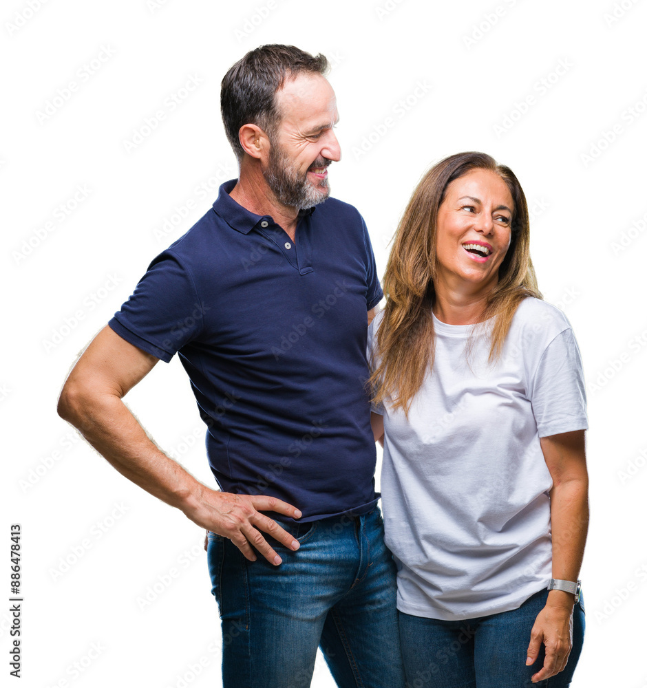 Middle age hispanic casual couple over isolated background looking away to side with smile on face, natural expression. Laughing confident. Middle age hispanic casual couple over isolated background looking away to side with smile on face, natural expression. Laughing confident.