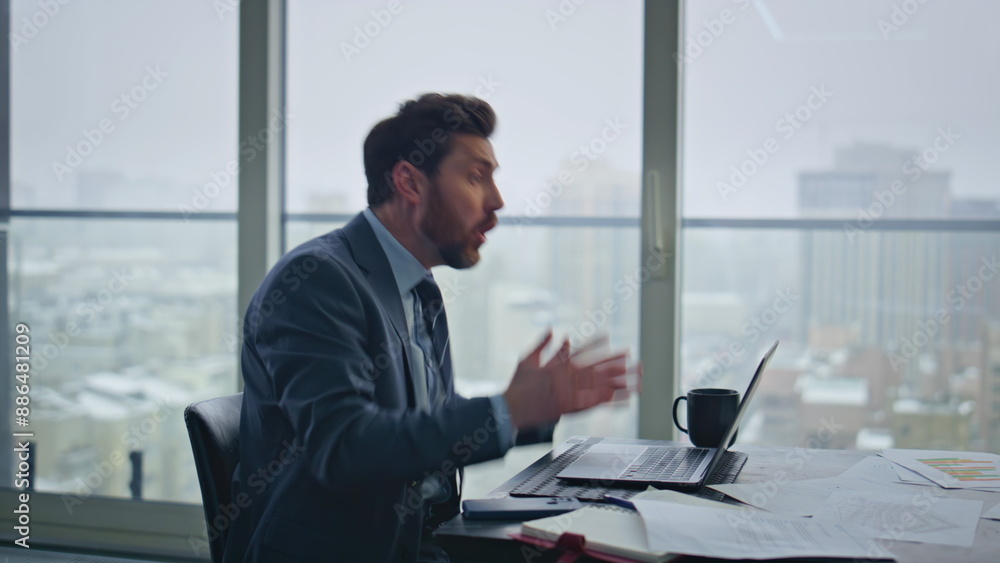 Fototapeta premium Nervous director arguing online at panoramic room closeup. Ceo closing laptop