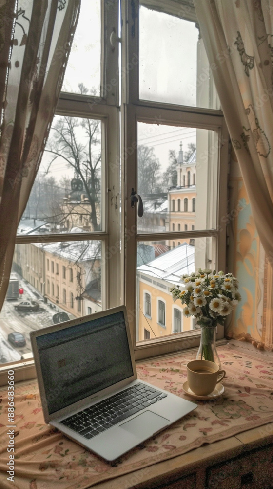 an open laptop on top of the desk, the table with A bouquet of daisies and coffee on it, an open laptop on top of the desk, the table with A bouquet of daisies and coffee on it,