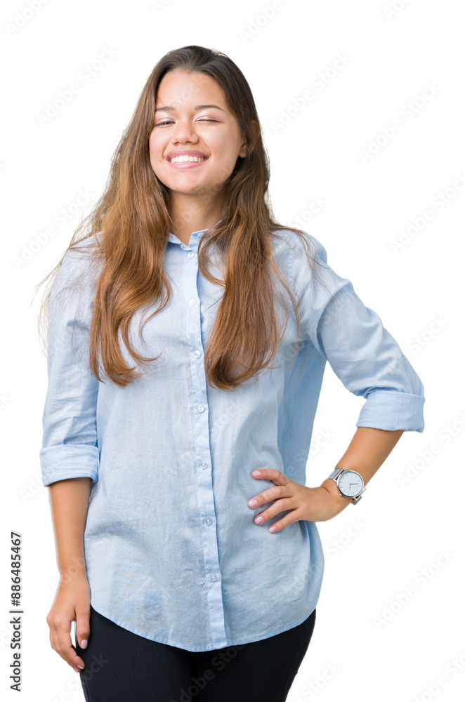 Obraz premium Young beautiful brunette business woman over isolated background winking looking at the camera with sexy expression, cheerful and happy face.
