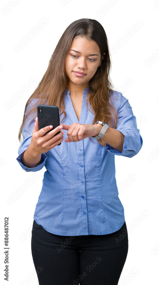 Young beautiful brunette business woman using smartphone over isolated background with a confident expression on smart face thinking serious Young beautiful brunette business woman using smartphone over isolated background with a confident expression on smart face thinking serious