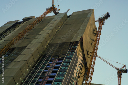 Construction site office building with crane sunset