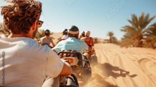 A group of quad bikers drive through a sandy desert, surrounded by sand dunes and palm trees, capturing the essence of adventure and exploration on a bright, sunny day. photo