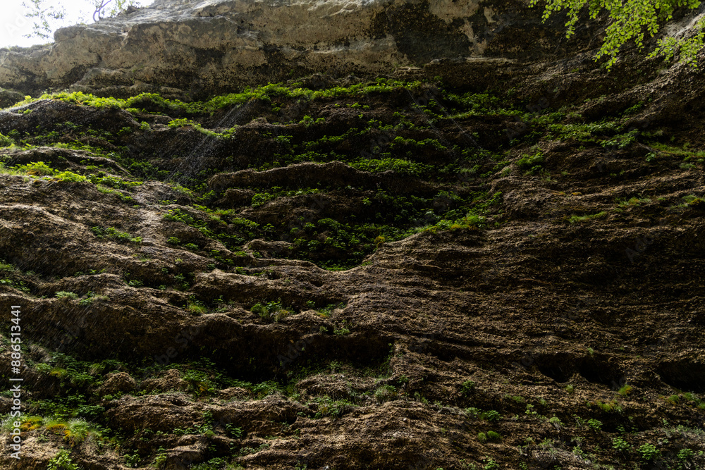 Obraz premium Perichnik waterfall is a beautiful drop from the mountain cliff, in Triglav National Park. Slovenian waterfall. Long for walking and trekking, enter inside the cave to admire it. Power and majesty.