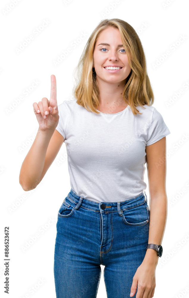 Beautiful young woman wearing casual white t-shirt over isolated background showing and pointing up with finger number one while smiling confident and happy. Beautiful young woman wearing casual white t-shirt over isolated background showing and pointing up with finger number one while smiling confident and happy.
