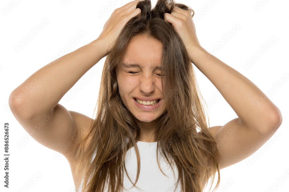 Exhausted young woman with eyes closed. Pain, stress and despair concept. White studio background. Exhausted young woman with eyes closed. Pain, stress and despair concept. White studio background.