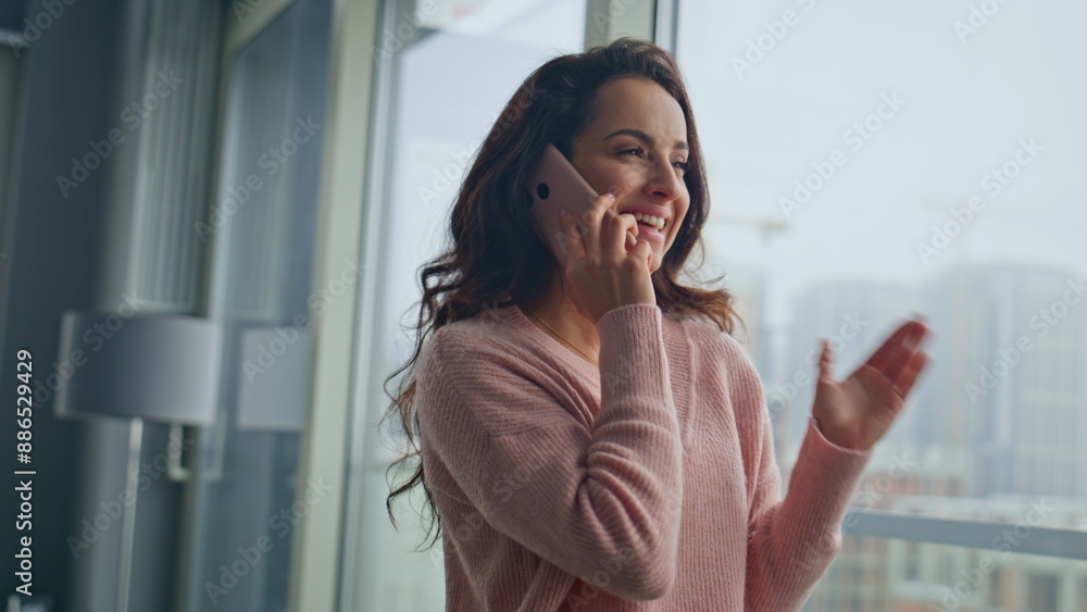 Fototapeta premium Attractive woman talking cell modern glass apartment closeup. Girl enjoying call
