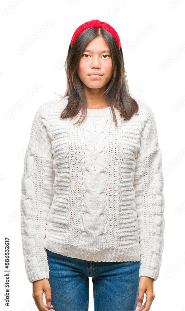 Young asian woman wearing winter sweater over isolated background with serious expression on face. Simple and natural looking at the camera. Young asian woman wearing winter sweater over isolated background with serious expression on face. Simple and natural looking at the camera.
