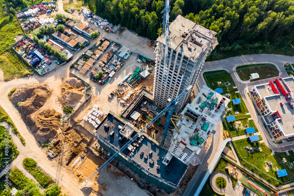 Fototapeta premium Drone view of the construction of a multi-storey building in a residential complex, construction site from the air