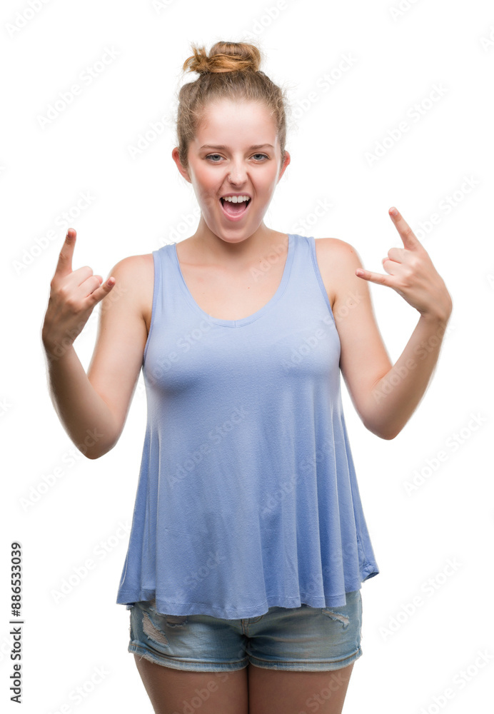 Young blonde woman shouting with crazy expression doing rock symbol with hands up. Music star. Heavy concept. Young blonde woman shouting with crazy expression doing rock symbol with hands up. Music star. Heavy concept.
