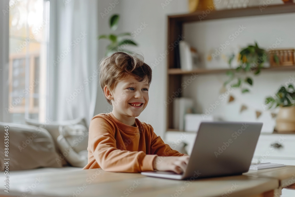 Preschool education concept. Cheerful smiling little child using a modern laptop at home. Development and education of children. Online training Preschool education concept. Cheerful smiling little child using a modern laptop at home. Development and education of children. Online training