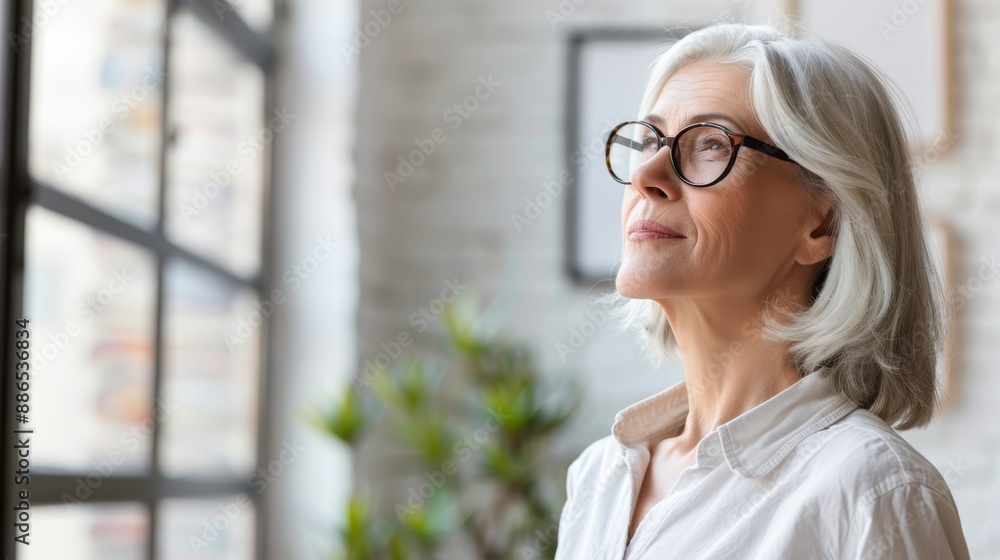 Elegant Senior Woman with Glasses Looking Up in Contemplation Elegant Senior Woman with Glasses Looking Up in Contemplation