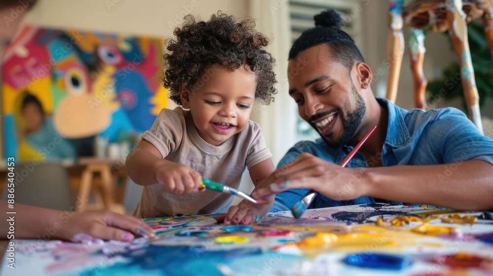 Fototapeta premium A man and a child are painting a picture together