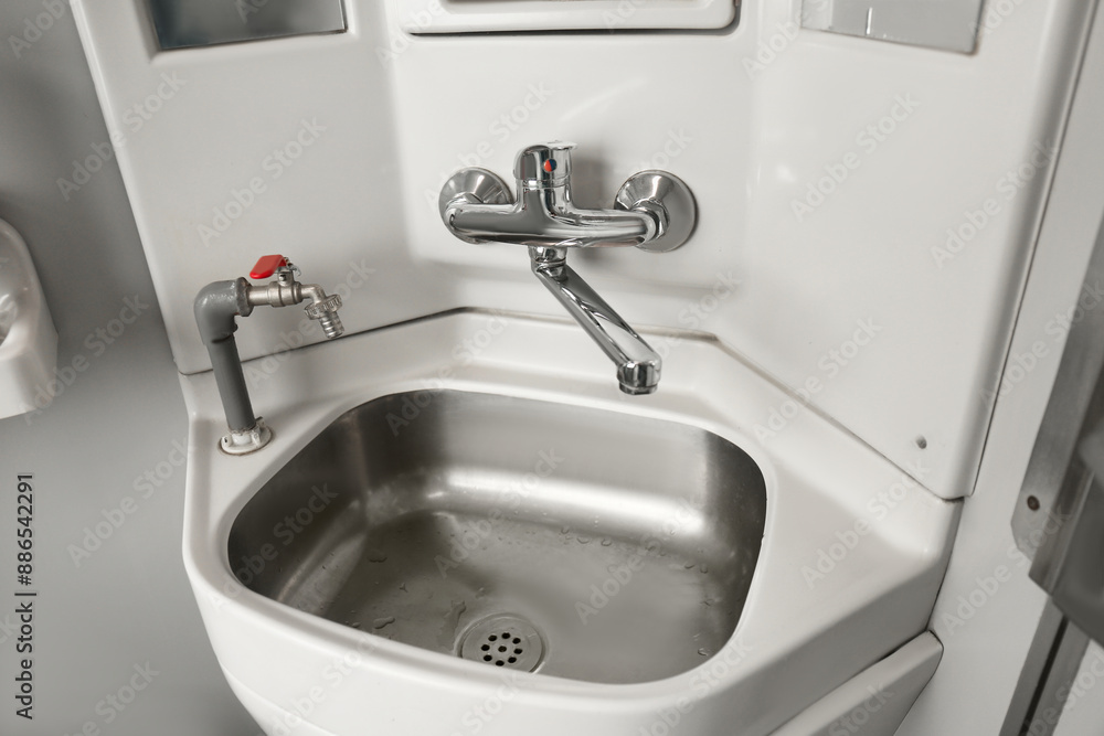 Stainless steel washbasin in train car restroom Stainless steel washbasin in train car restroom