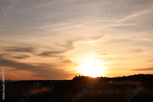 Picturesque view of countryside under beautiful sky at sunset