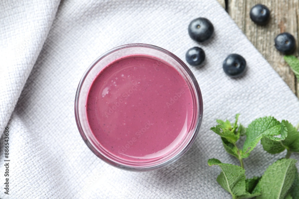 Tasty fresh acai juice in glass with berries and mint on table, flat lay Tasty fresh acai juice in glass with berries and mint on table, flat lay
