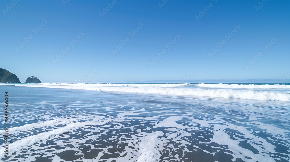 A minimalist shot of foamy waves under a clear blue sky at Piha beach A minimalist shot of foamy waves under a clear blue sky at Piha beach