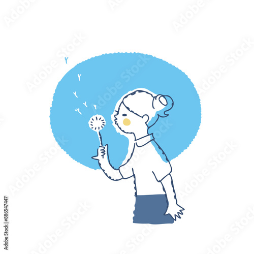 タンポポの綿毛に息を吹きかけて遊ぶ女の子