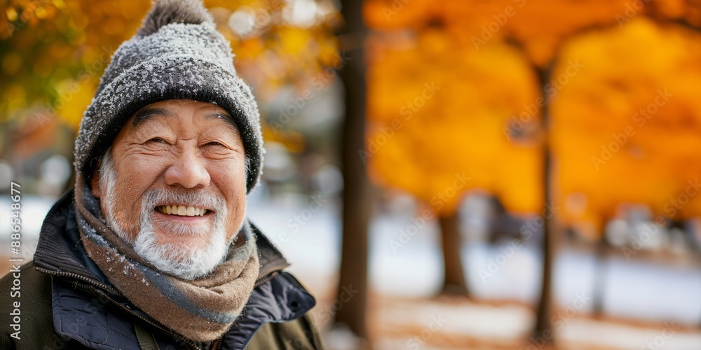 Asian man is smiling outdoors in the city. Winter clothing. Portrait of happy senior man in winter jacket looking at camera. Asian man is smiling outdoors in the city. Winter clothing. Portrait of happy senior man in winter jacket looking at camera.