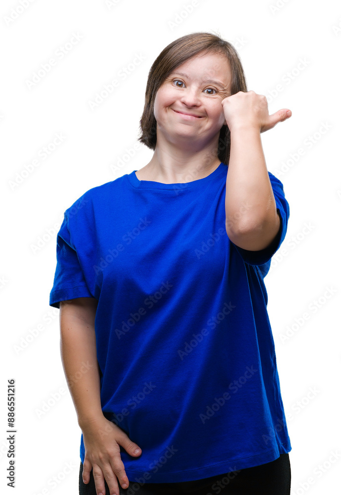 Young adult woman with down syndrome over isolated background smiling with happy face looking and pointing to the side with thumb up. Young adult woman with down syndrome over isolated background smiling with happy face looking and pointing to the side with thumb up.