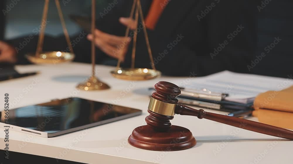 justice and law concept. asian woman lawyer working and judge in a courtroom the gavel, working with tablet and laptop and digital tablet computer on white table justice and law concept. asian woman lawyer working and judge in a courtroom the gavel, working with tablet and laptop and digital tablet computer on white table
