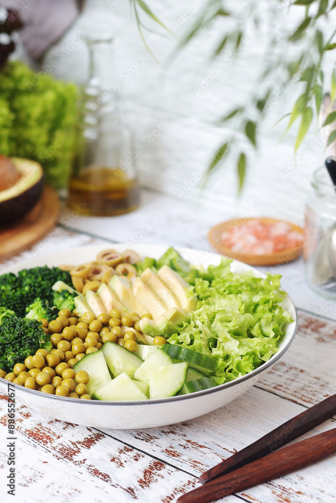 A bowl with a salad made of green vegetables A bowl with a salad made of green vegetables