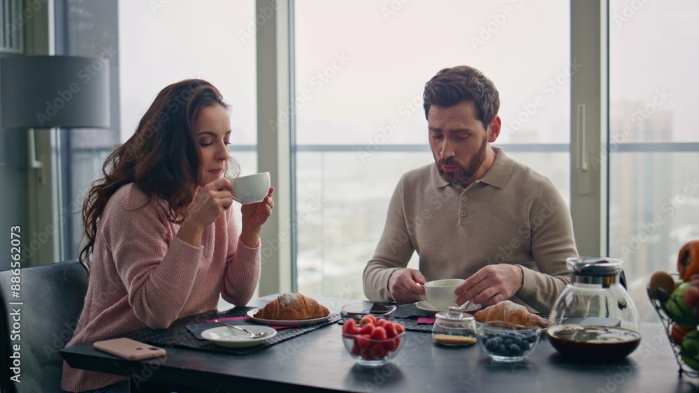 Happy couple drinking coffee at city view kitchen home closeup. Spouses leisure Happy couple drinking coffee at city view kitchen home closeup. Spouses leisure