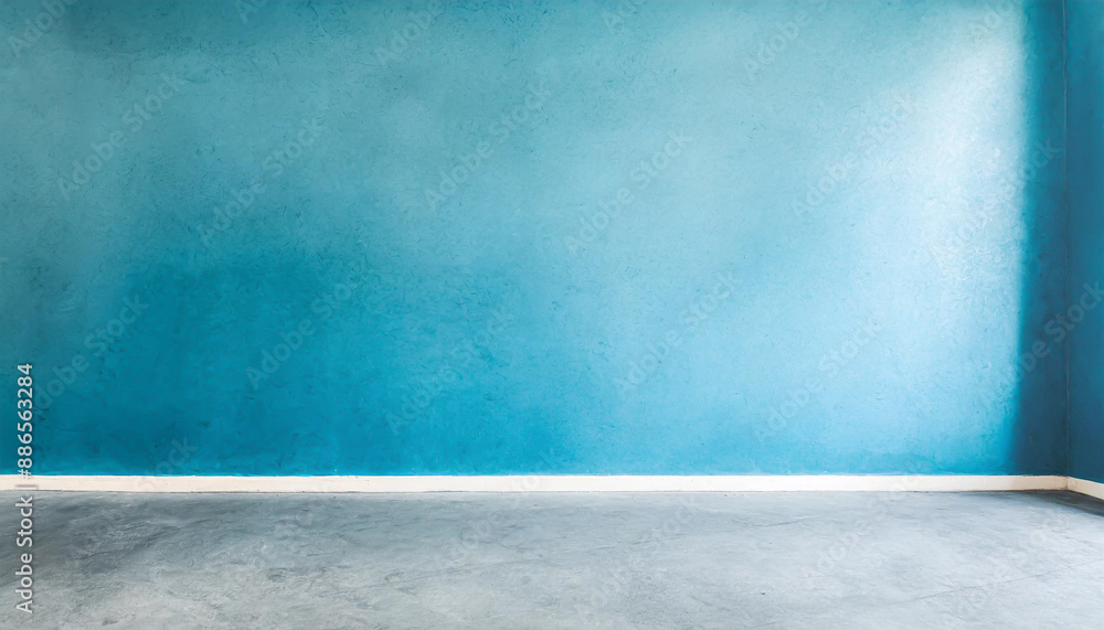 Blue wall in an empty room with concrete floor Blue wall in an empty room with concrete floor