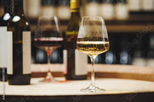 Close-Up of Wine Glasses on Wooden Barrel in Cellar