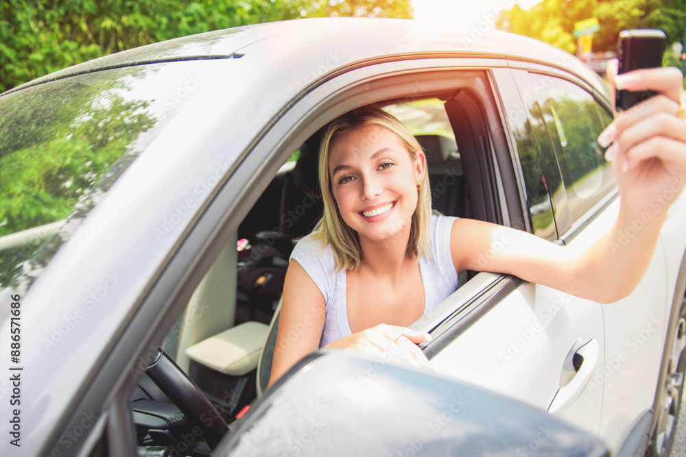 Naklejka premium Happy teen girl driver on car on summer day