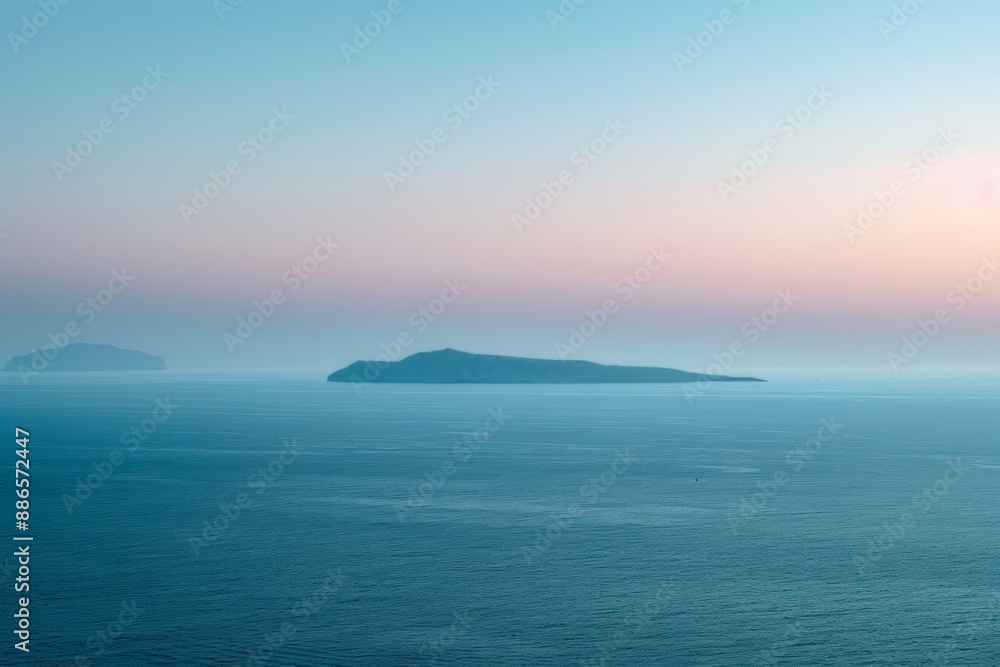 Obraz premium An idyllic view of a serene sea at dusk, with a silhouetted island in the distance, under a gradient sky from pink to blue.