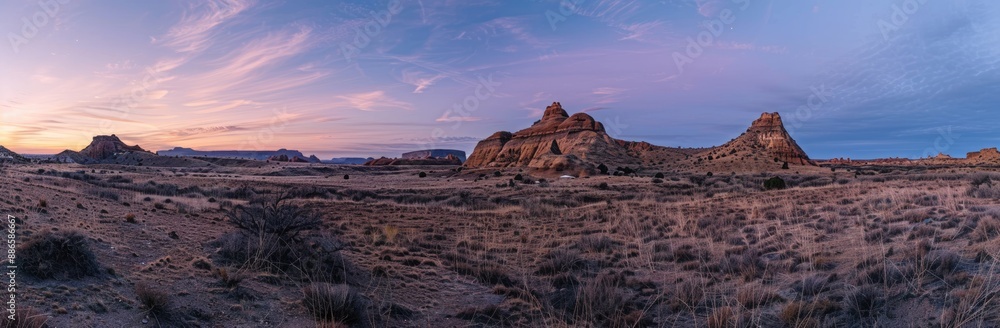 Obraz premium Sunset Over a Desert Landscape with Dramatic Rock Formations