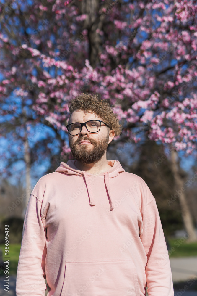 Man allergic enjoying after treatment from seasonal allergy at spring. Portrait of happy bearded man smiling in front of blossom tree at springtime. Spring blooming and allergy concept. Copy space Man allergic enjoying after treatment from seasonal allergy at spring. Portrait of happy bearded man smiling in front of blossom tree at springtime. Spring blooming and allergy concept. Copy space