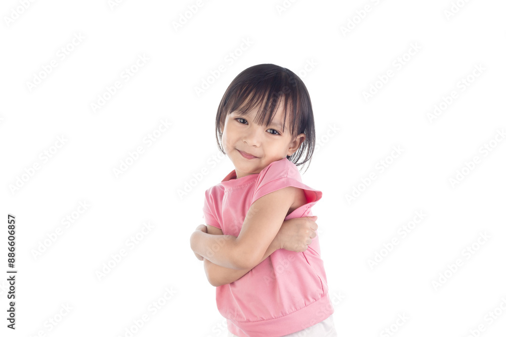 A cute Asian little girl stands with her arms folded and smiling happily isolated on white background with clipping paths. A cute Asian little girl stands with her arms folded and smiling happily isolated on white background with clipping paths.