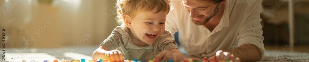 happy father and son playing with colorful toys together at home in warm sunlight. happy father and son playing with colorful toys together at home in warm sunlight.