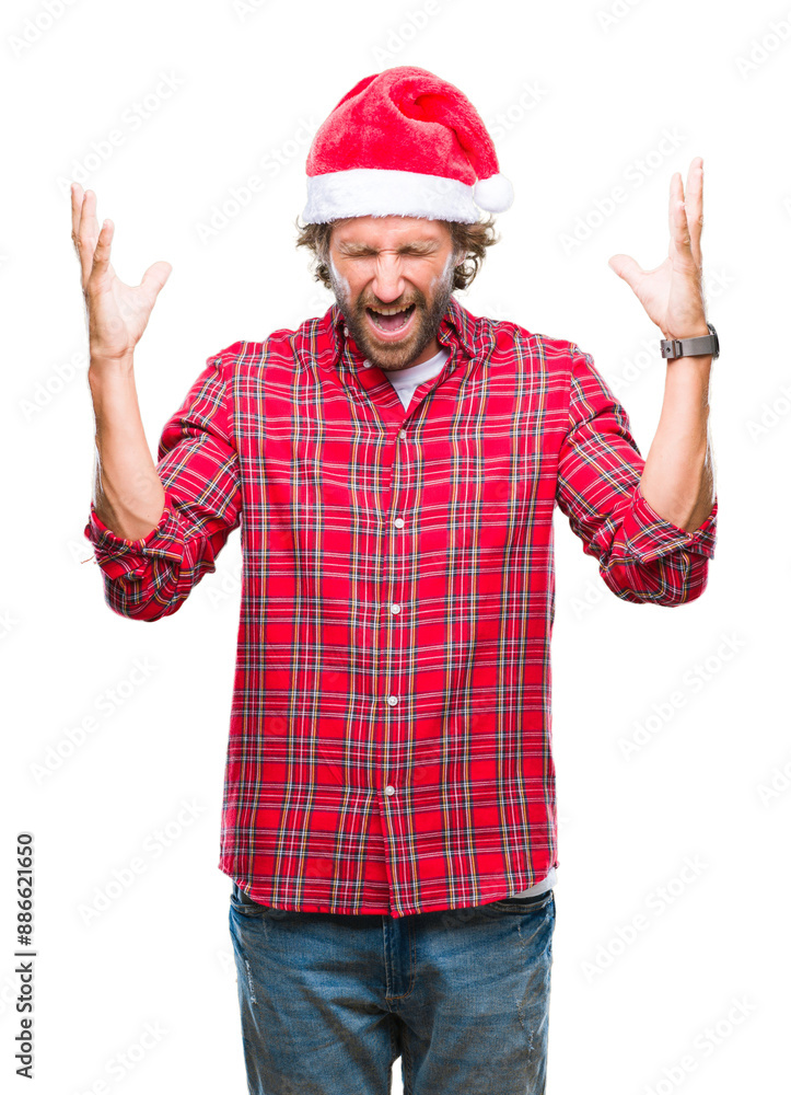 Handsome hispanic man model wearing santa claus christmas over isolated background celebrating mad and crazy for success with arms raised and closed eyes screaming excited. Winner concept Handsome hispanic man model wearing santa claus christmas over isolated background celebrating mad and crazy for success with arms raised and closed eyes screaming excited. Winner concept
